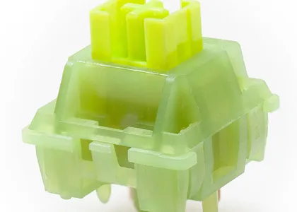 Green mechanical keyboard switch on a white background