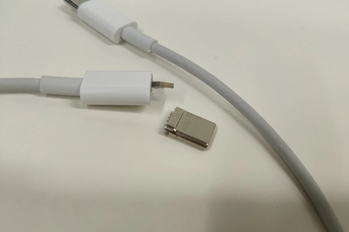 Broken USB-C cable with a separated connector, ready for inspection