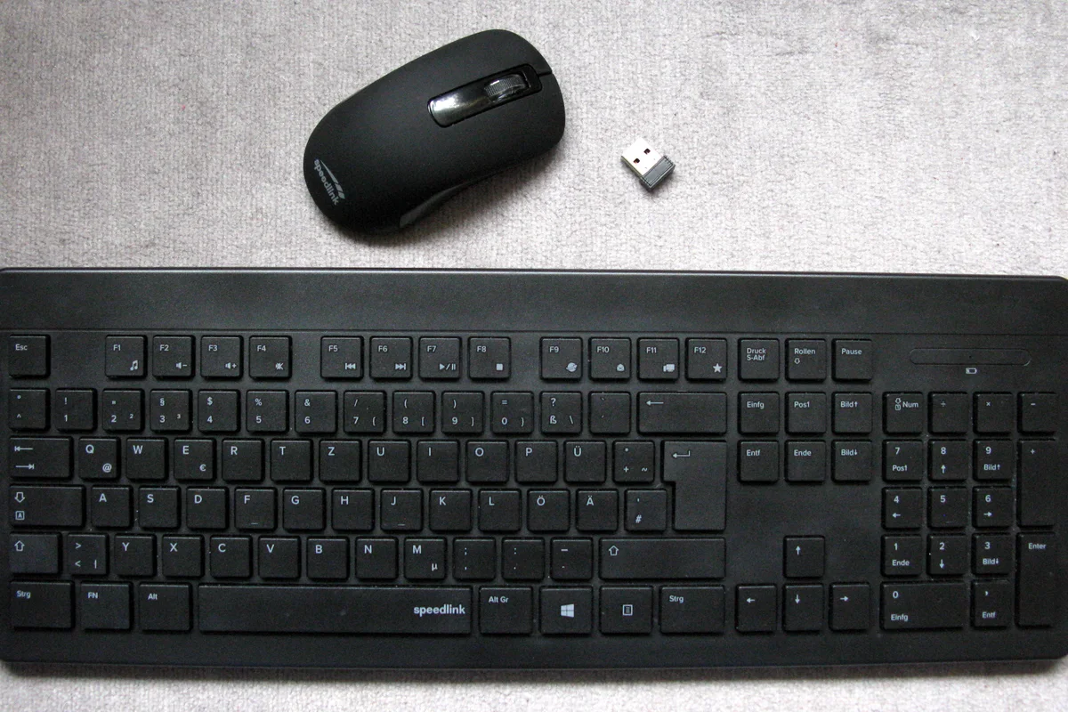 Dedicated USB receiver shown beside a wireless keyboard and mouse