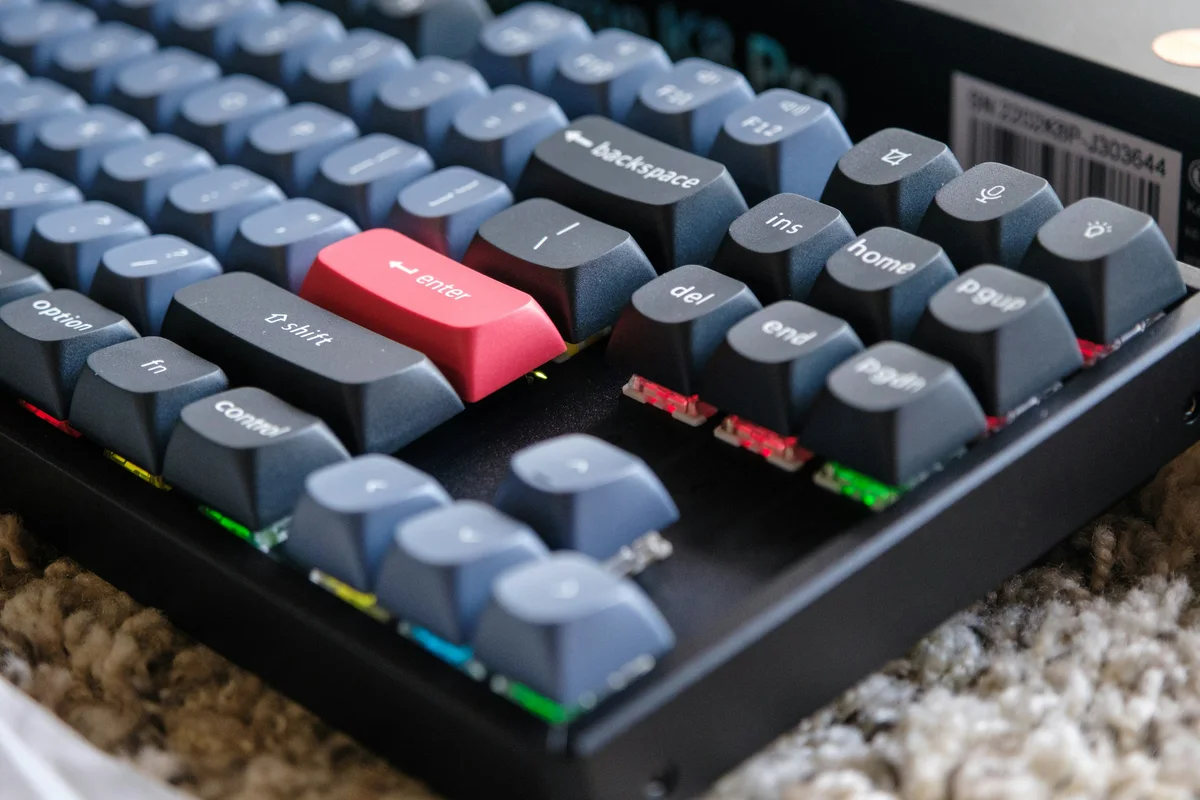 Low-angle close-up showing how keycap height and top shape change across sculpted rows