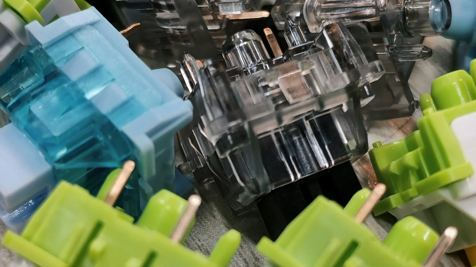 Pile of mechanical keyboard switches with colorful stems and housings